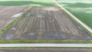Aerial view of fields and roadside ditches with standing water 